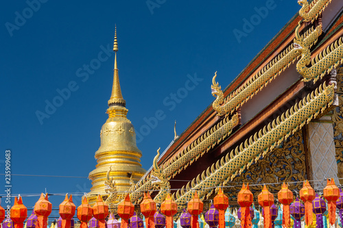 Wat Phra That Hariphunchai The province Lampoon of Thailand. There is a statue of Kruba Srichai in the temple.The temple has a golden pagoda. And green lawns. And the beautiful temple gazebo. photo