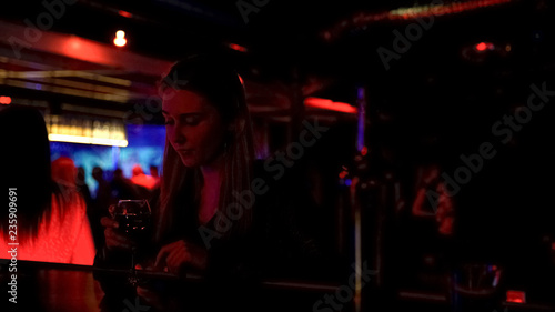 Upset lonely lady drinking wine at bar counter in night club, life problems