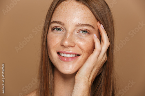 Beauty portrait of a smiling young topless woman
