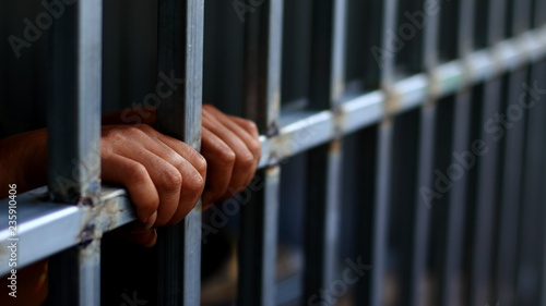 Fotografie, Obraz The prisoner handles the prison in jail no freedom concept