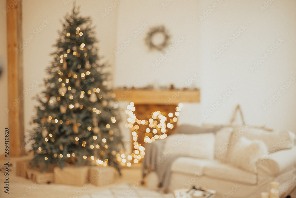 New Year background. Christmas Room Interior Design, Xmas Tree Decorated By Lights Presents Gifts Toys, Candles And Garland Lighting Indoors