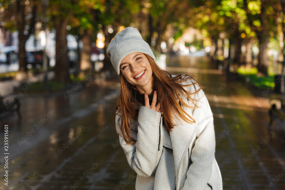Cheerful young woman dressed in autumn coat Cheerful young woman dressed in autumn coat