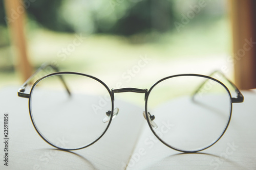 Black glasses on books stack in public library book, Study examining. Tutor books with friends.learning People learning, education