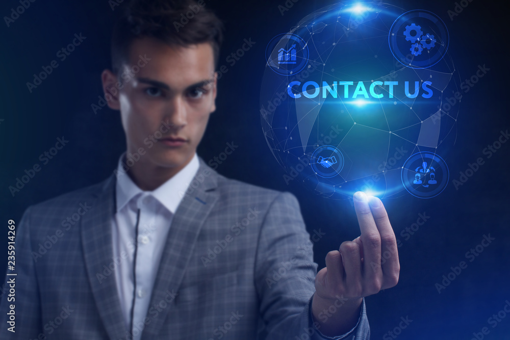 The concept of business, technology, the Internet and the network. A young entrepreneur working on a virtual screen of the future and sees the inscription: Contact us The concept of business, technology, the Internet and the network. A young entrepreneur working on a virtual screen of the future and sees the inscription: Contact us