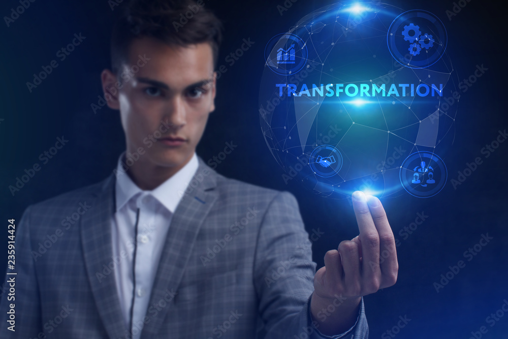 The concept of business, technology, the Internet and the network. A young entrepreneur working on a virtual screen of the future and sees the inscription: Transformation The concept of business, technology, the Internet and the network. A young entrepreneur working on a virtual screen of the future and sees the inscription: Transformation