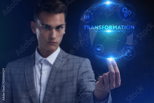 The concept of business, technology, the Internet and the network. A young entrepreneur working on a virtual screen of the future and sees the inscription: Transformation