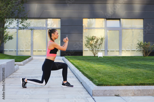 Fitness girl stretching after training outdoors