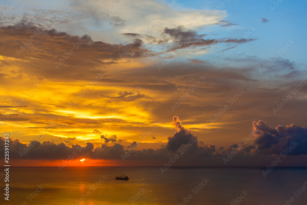 Magnificent colored clouds on the sea at sunset in the evening