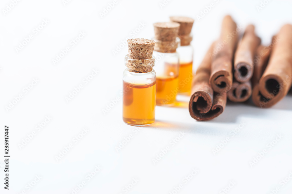 Essential oil cinnamon in glass bottle. Spa concept
