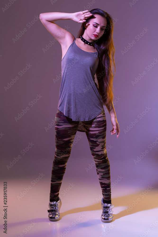 Modern style dancer posing on studio background. Hip hop, jazz funk, dancehall Modern style dancer posing on studio background. Hip hop, jazz funk, dancehall