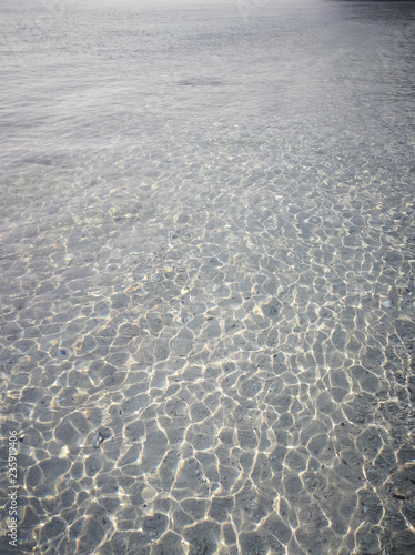 Photo of the amazing crystal clear water  in the shallow shimmering part of the pristine beach of Redang Island. Popular for snorkelling tourism.