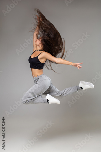 Modern style dancer posing on studio background. Hip hop, jazz funk, dancehall © nazarovsergey