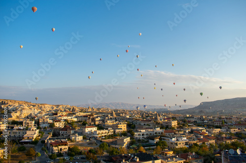 Aerial view on Sunrise over Cappadocia. Balloons flying against blue sky. Goreme most popular place in Turkey 