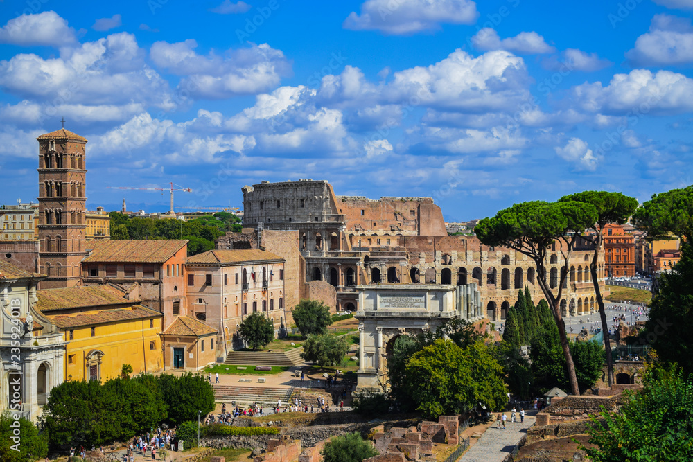 Rome Forum and Coliseum cityscape, with blue sky and white clouds, Italy