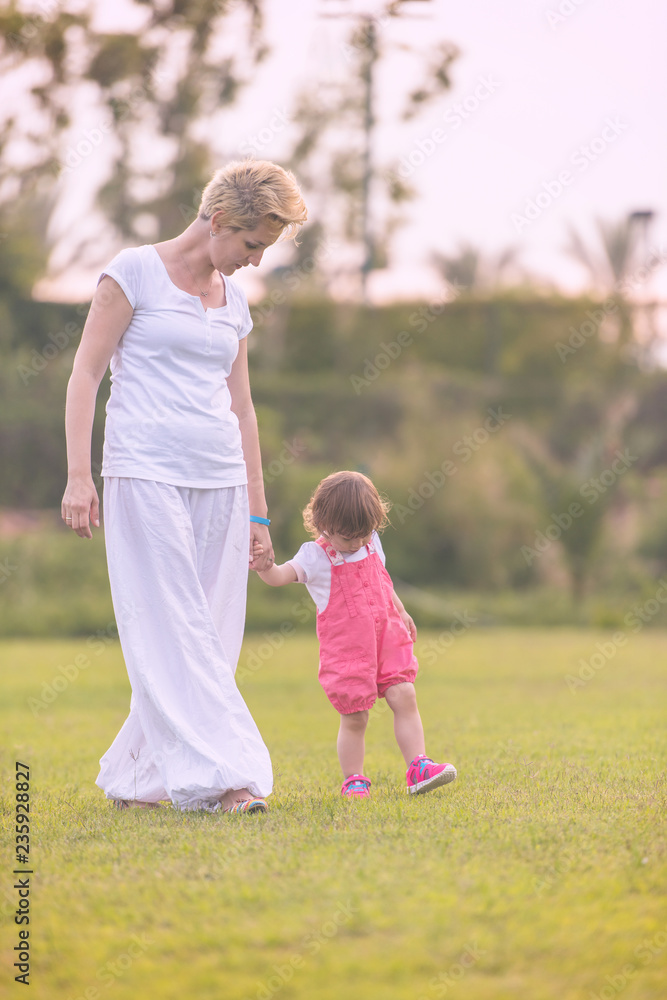 Fototapeta premium mother and little daughter playing at backyard