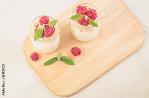 yogurt with berry and mint on the tray/Healthy summer yogurt with berry and mint on the wooden tray, top view