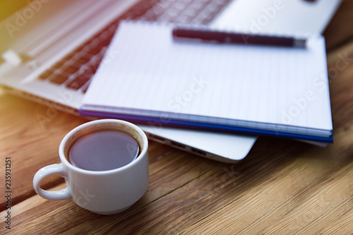 Notepad on keyboard with coffee