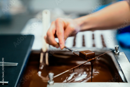 Person holding a chocolate dipped candy
