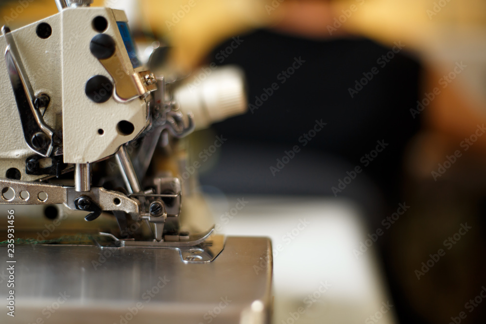closeup details on sewing machine overlock. Workplace seamstress.Tailoring industry closeup details on sewing machine overlock. Workplace seamstress.Tailoring industry