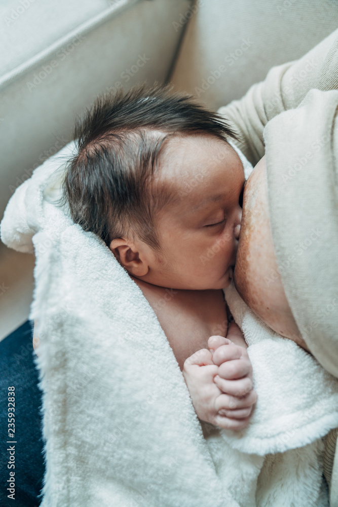 Mother breastfeeding her newborn baby Mother breastfeeding her newborn baby
