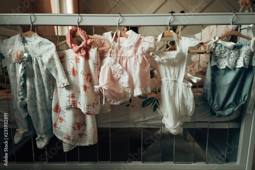 Baby clothing hung in a closet photo