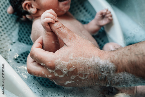 Father giving newborn baby a bath