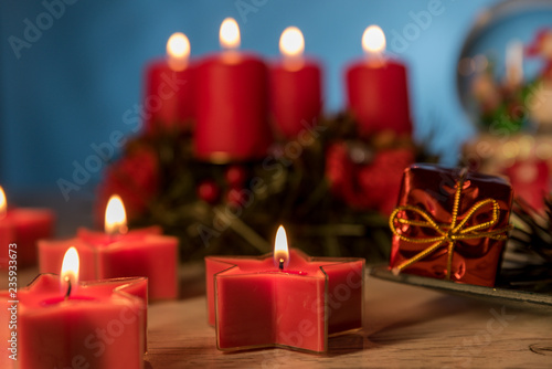 Christmas ball and burning candles on blue background Christmas and winter decoration