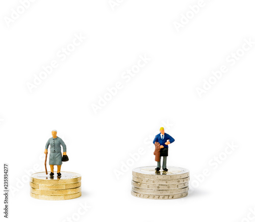 Small figurines and coins. Gender pay gap.
