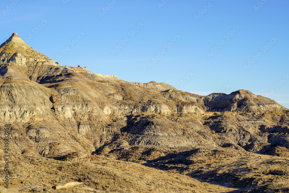 Rocky cliffs with bright sunshine and blue sky in Eastern Montana badlands, near Miles City, MT. Copy space available
