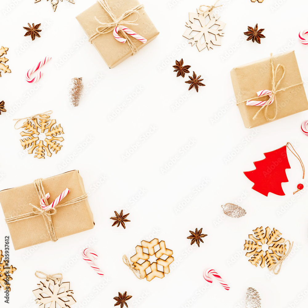 Christmas gifts, decorations and candy canes on white background. Flat lay, top view. Winter frame composition Christmas gifts, decorations and candy canes on white background. Flat lay, top view. Winter frame composition