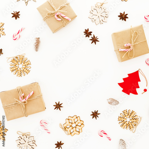Christmas gifts, decorations and candy canes on white background. Flat lay, top view. Winter frame composition