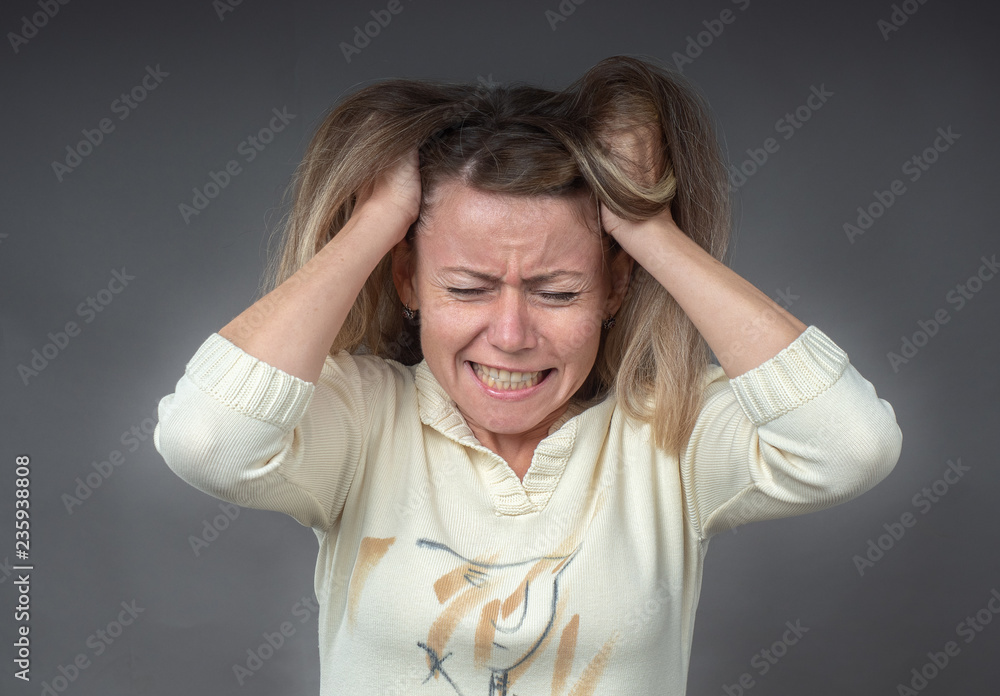 Woman in stress. Closeup portrait of screaming hysterical angry woman isolated on gray background. Girl in despair and panic. Negative human emotion face expression concept of conflict confrontation. Woman in stress. Closeup portrait of screaming hysterical angry woman isolated on gray background. Girl in despair and panic. Negative human emotion face expression concept of conflict confrontation.