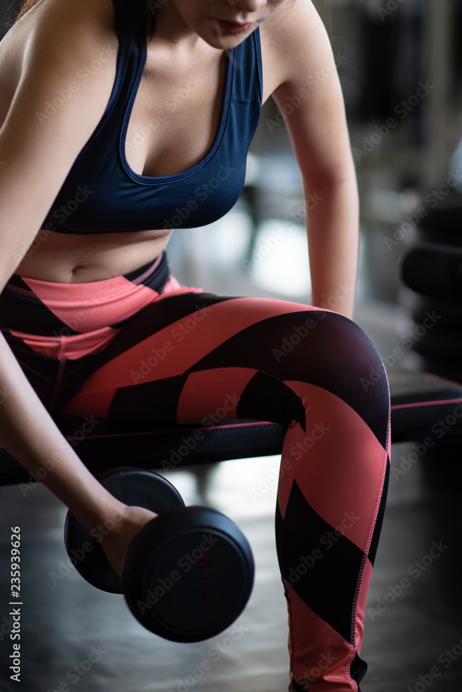 Fitness woman in training exercises with dumbbells. Fitness woman in training exercises with dumbbells.