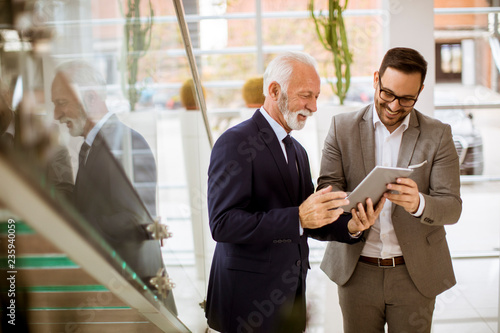 Senior businessman pointing...