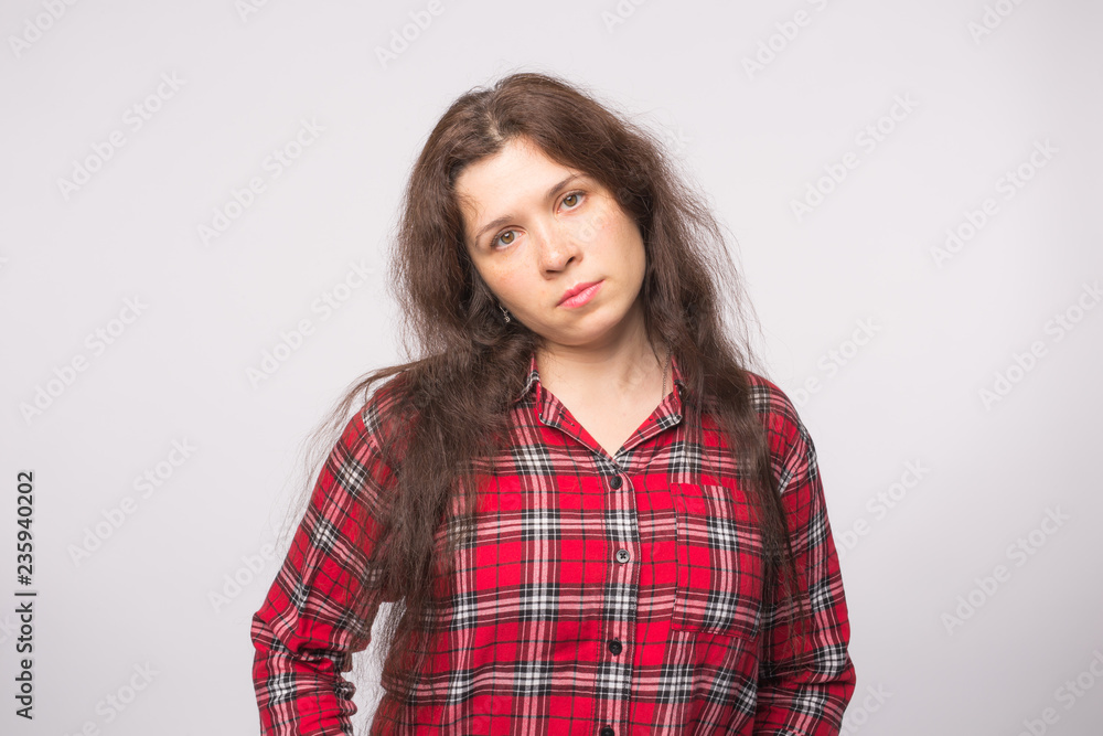 Feelings, emotions and people concept - Sad unhappy young woman on white background Feelings, emotions and people concept - Sad unhappy young woman on white background
