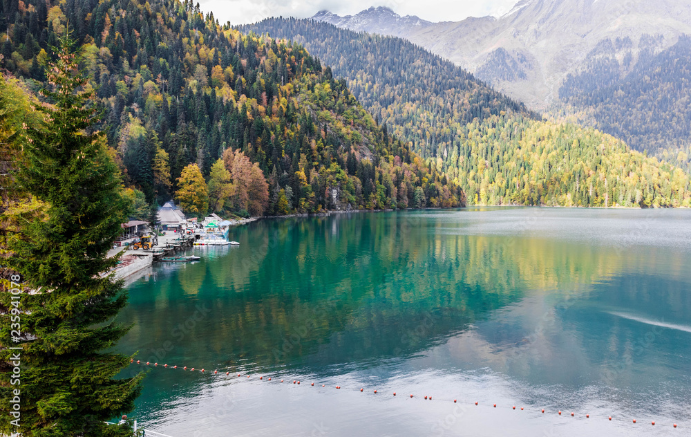 Beautiful lake surrounded by mountains and forests in autumn, Ritsa, Abkhazia.