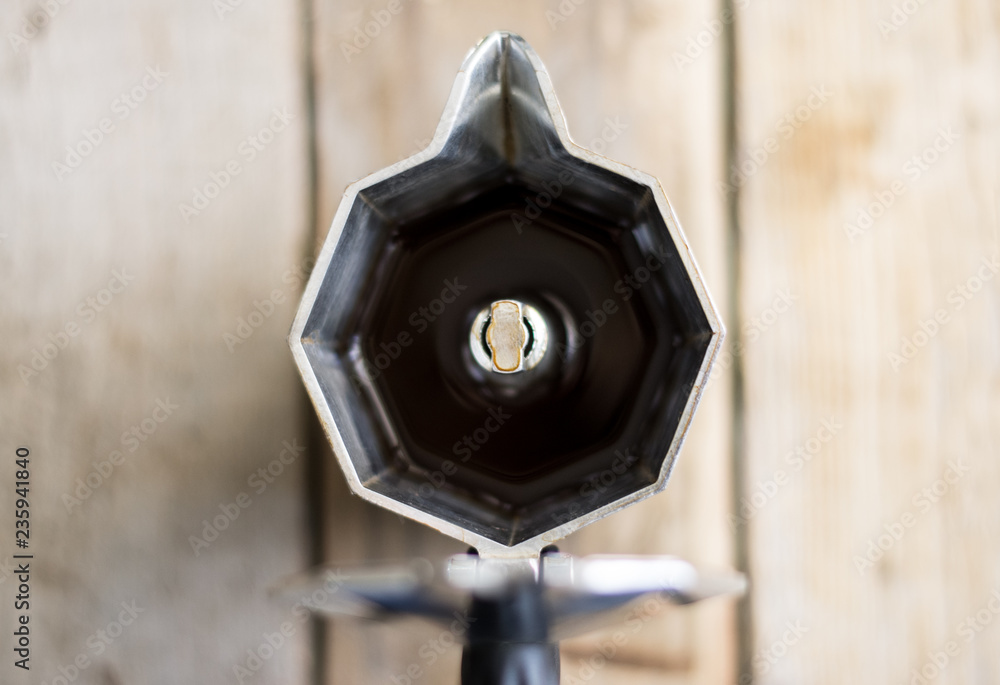 Isolated espresso coffee maker from the top on the wooden background Isolated espresso coffee maker from the top on the wooden background