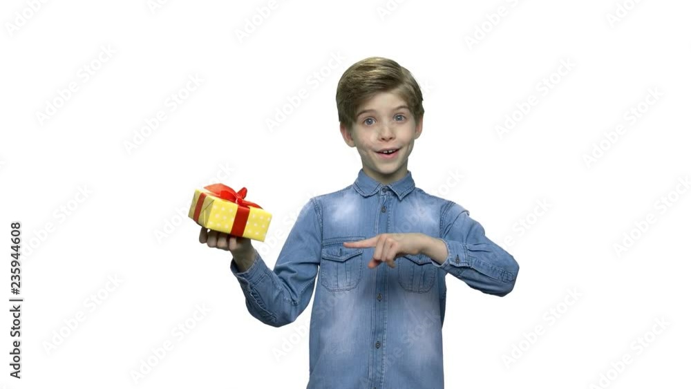 Portrait of surprised kid with gift box. Attractive boy holding box with present and looking at camera. Special holiday offer. Portrait of surprised kid with gift box. Attractive boy holding box with present and looking at camera. Special holiday offer.