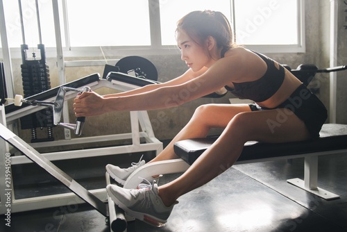 woman exercising building muscles at gym