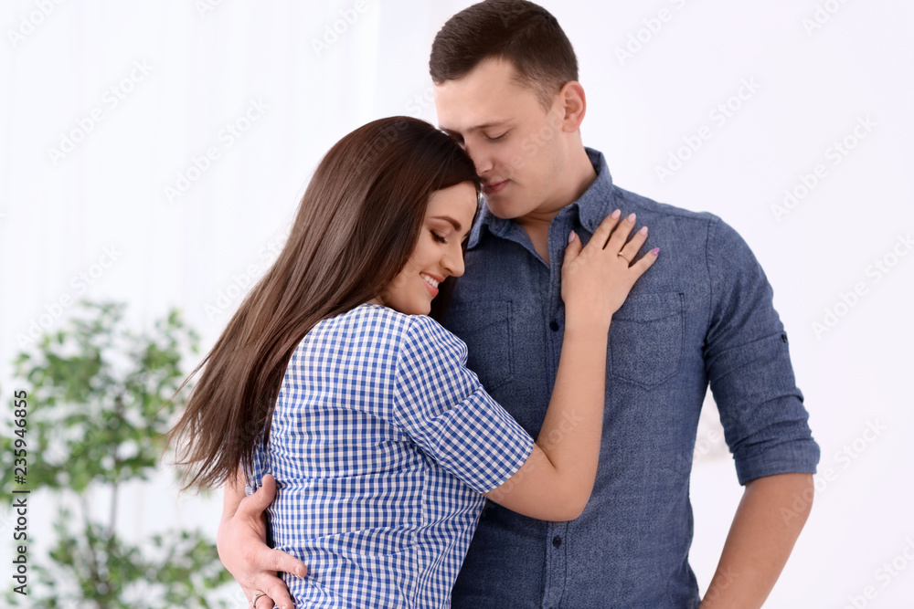 Portrait of young loving couple at home