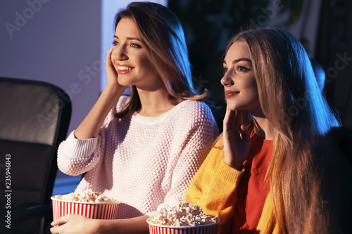 Young women watching movie ...