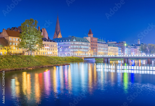 Obraz na płótnie Night city view. Cityscape of Malmo at the evening, Sweden. Beautiful European town reflected in water w salonie