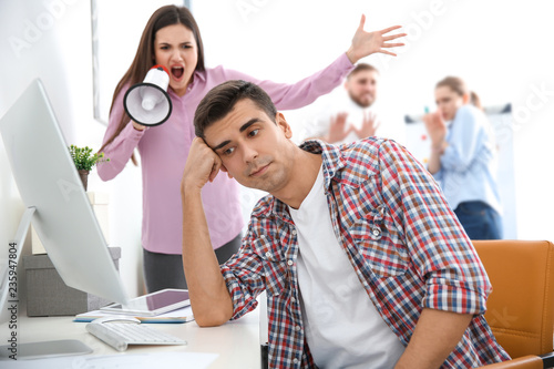Angry boss with megaphone s...