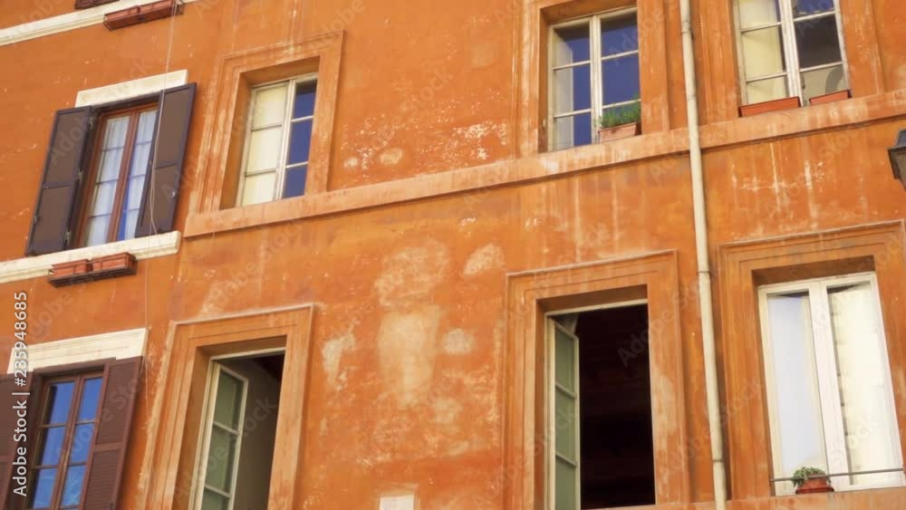 Beautiful european urban architecture. Exterior of old residential building in center of Rome, Italy. Colorful facade of roman house. Camera moving sideways in slow motion Beautiful european urban architecture. Exterior of old residential building in center of Rome, Italy. Colorful facade of roman house. Camera moving sideways in slow motion