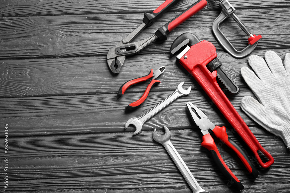Flat lay composition with plumber's tools and space for text on wooden background Flat lay composition with plumber's tools and space for text on wooden background
