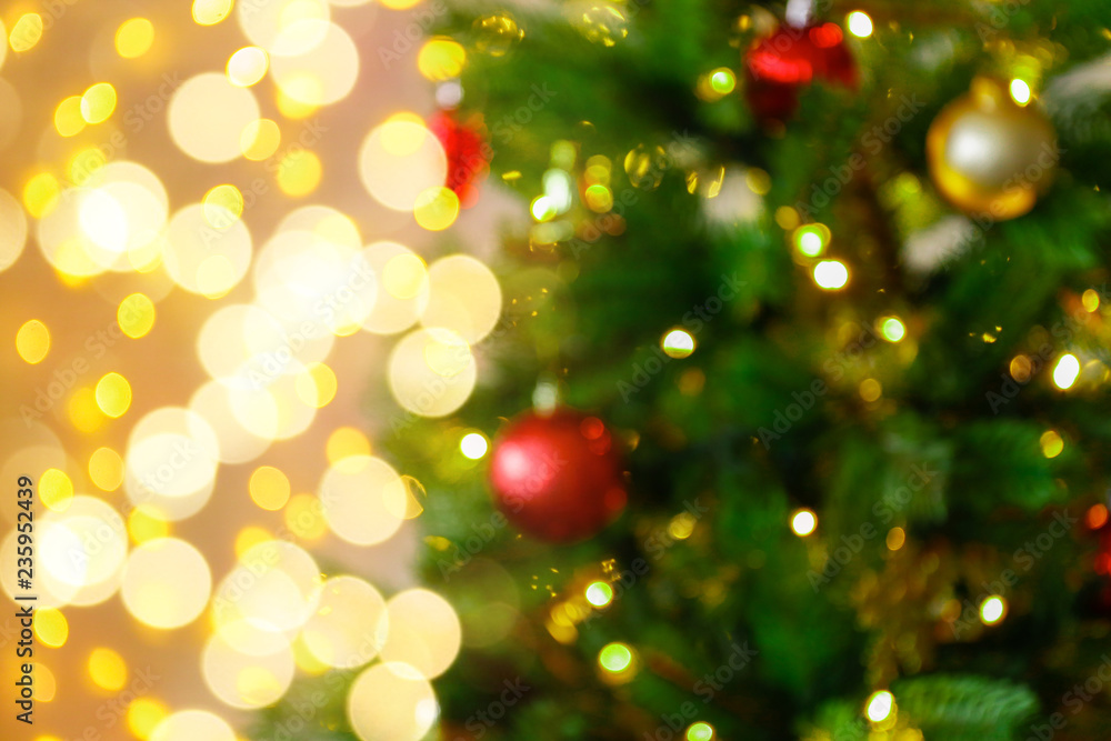 Decorated Christmas tree on soft yellow lights with bokeh effect background. Festive composition with fir and blurry sparkling backdrop, new year holiday decorations. Close up, copy space. Decorated Christmas tree on soft yellow lights with bokeh effect background. Festive composition with fir and blurry sparkling backdrop, new year holiday decorations. Close up, copy space.
