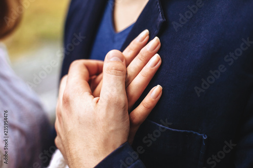 Young couple in love for a walk in the autumn forest. Close-up of lovers ' hands