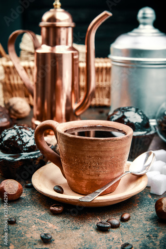 Crafting coffee in clay cup with bean cezve and chocolate cake