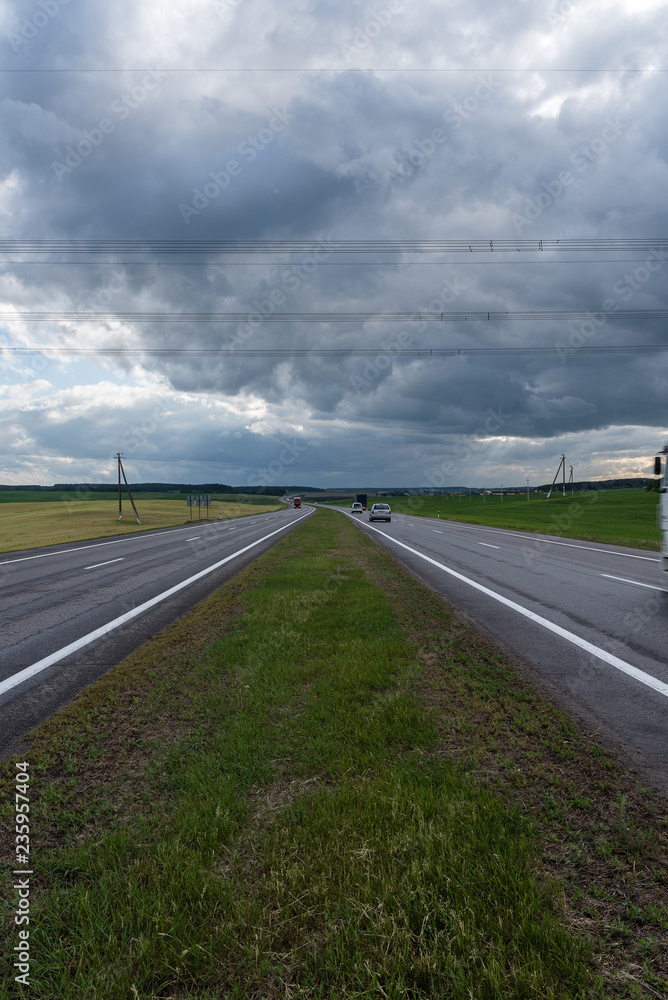 Fototapeta premium Highway before the storm. Dramatic clouds