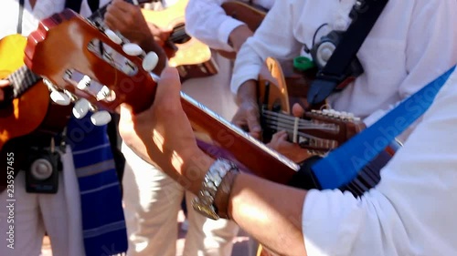 Local band on traditional clothes playing guitar on special event in Gran Canaria island, Spain. Musicians on party celebration in Canary Islands